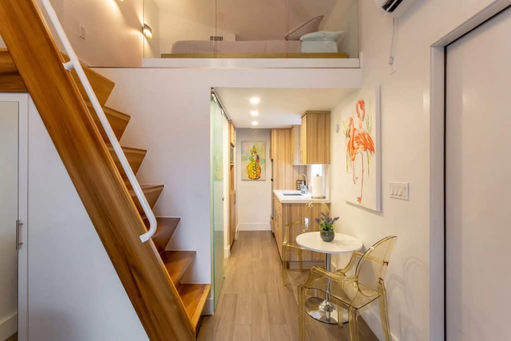 Photo of the Casa de Reg Airbnb in Miami showing the kitchen, breakfast nook, and loft. 