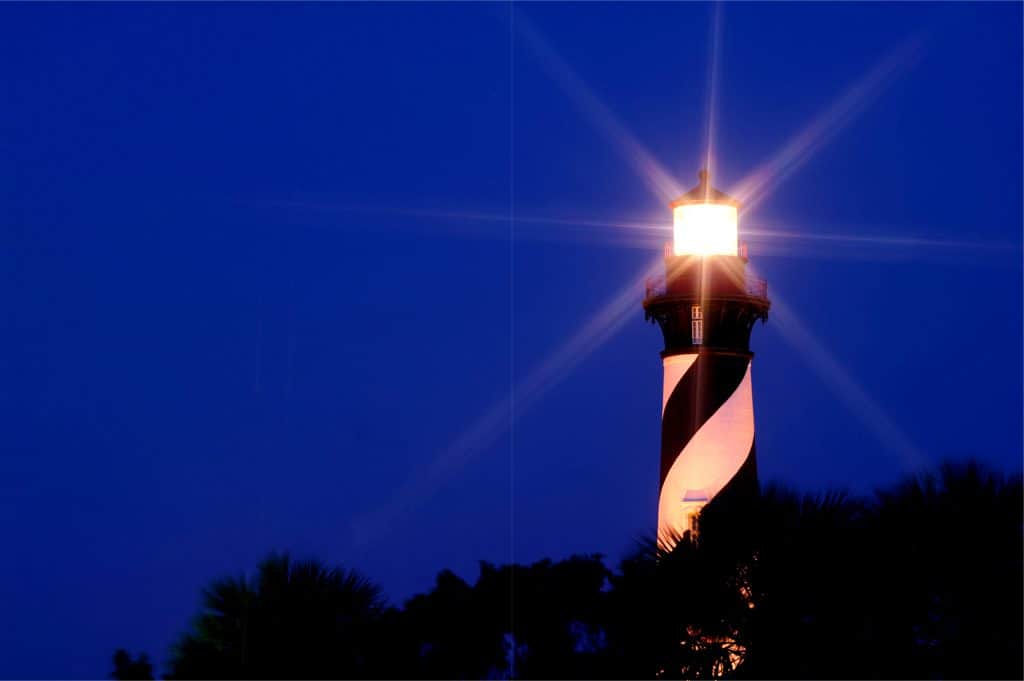 Nighttime photo of old lighthouse which can be seen on a Saint Augustine lighthouse ghost tour. 