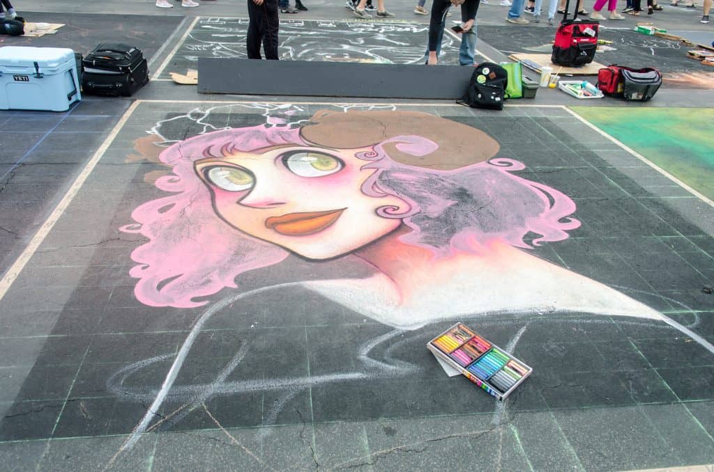 A chalking piece of a woman with pink hair at the International Chalking Festival.