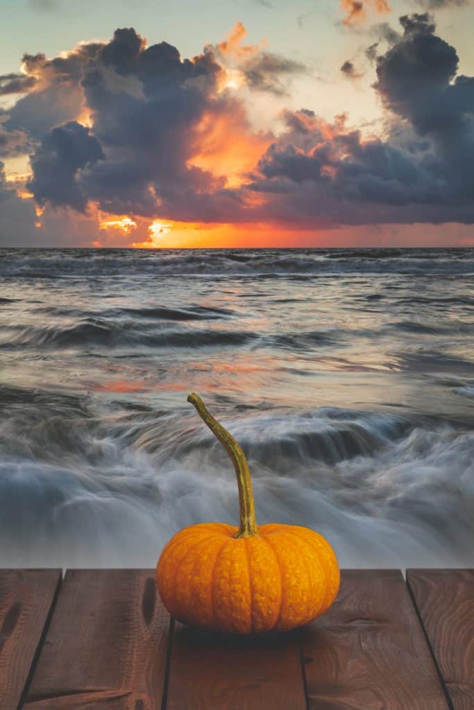 A pumpkin sits on a dock as waves crash, ringing in the beginning of fall in Florida.