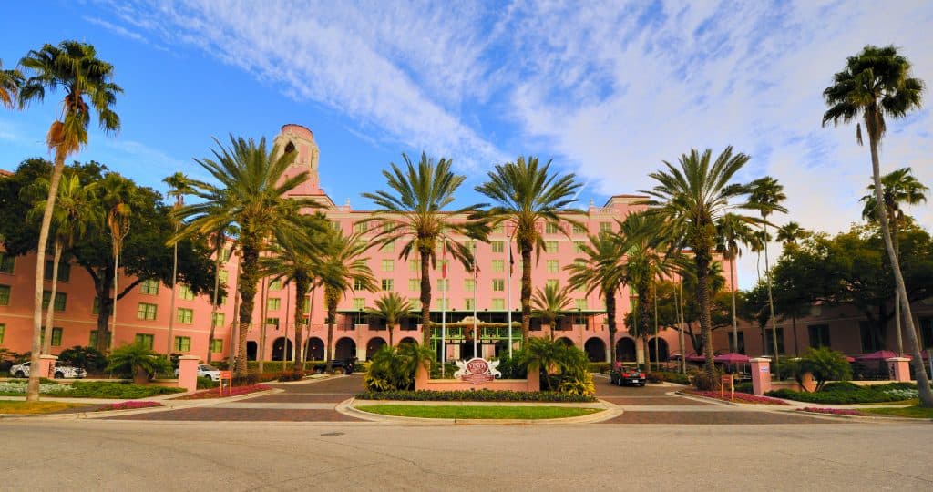 The upscale Vinoy Hotel's beautiful salmon pink exterior surrounded by palm trees in downtown St. Pete.