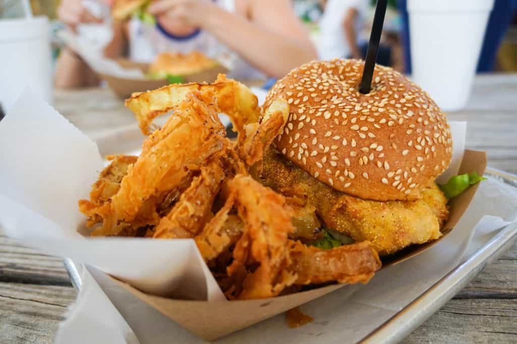 The infamous Grouper Burger at Big Ray's Fish Camp with hand-battered onion rings, one of the best restaurants in Tampa.