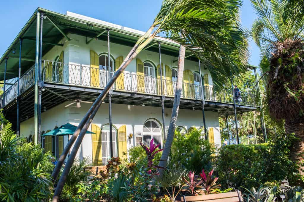 The Ernest Hemingway Museum stands on his former residence in Key West, Florida, surrounded by lush gardens.