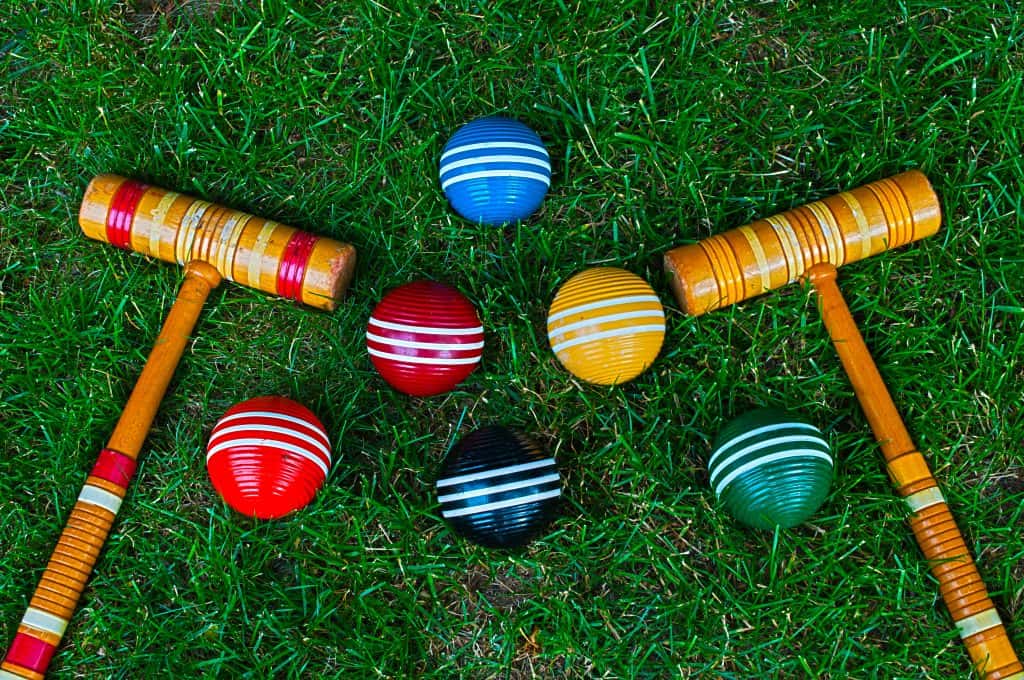 Croquet mallets and balls on a perfectly manicured lawn at the National Croquet Center in West Palm Beach, Florida.