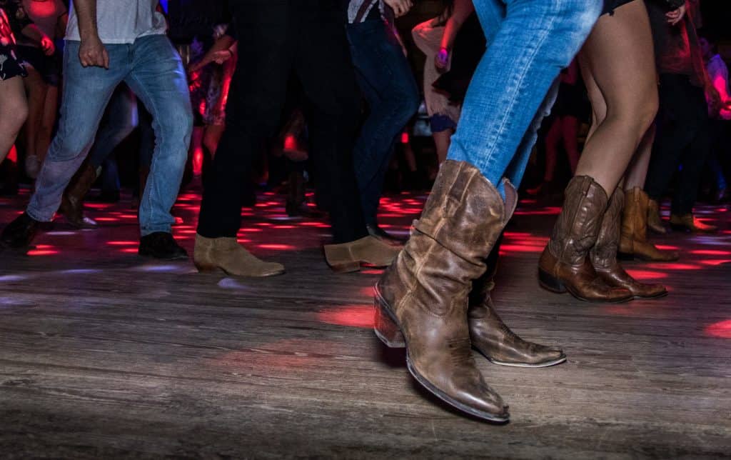 Photo of people country line dancing.