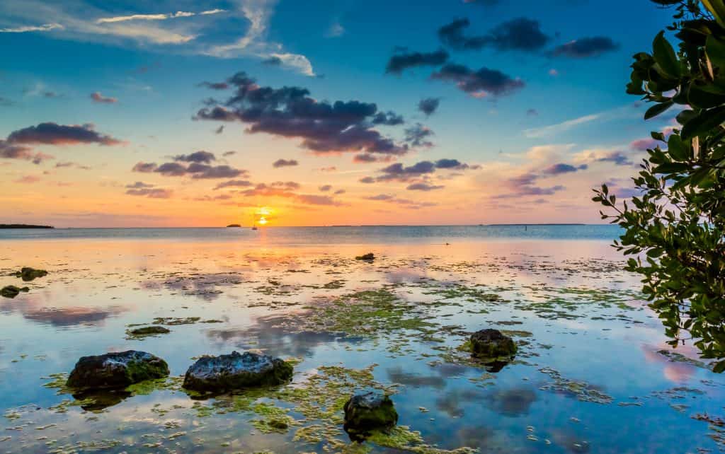 The sun sets on the waters of the Key Largo Kampground and Marinas, one of your best options for Florida Keys camping.