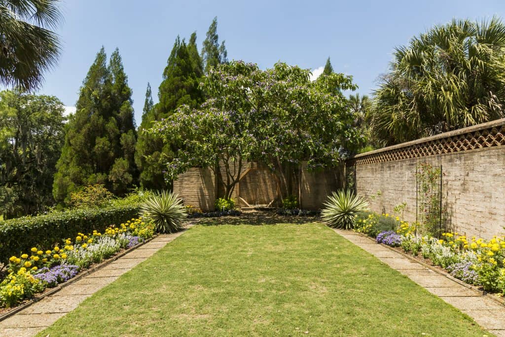 An octagonal door lies at the edge of a garden along the trails at Bok Tower Gardens.