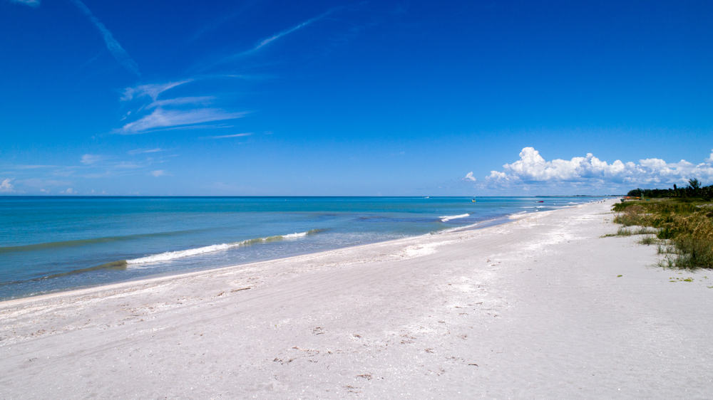 Gorgeous white sand beaches and blue waters of Sanibel Island, a great place for a romantic getaway in Florida.