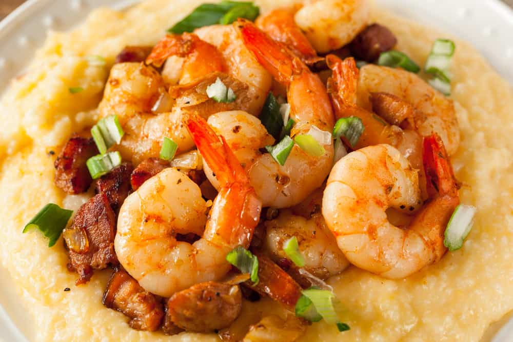 Try the shrimps n' grits at the Conch House a Caribbean style restaurant on the water