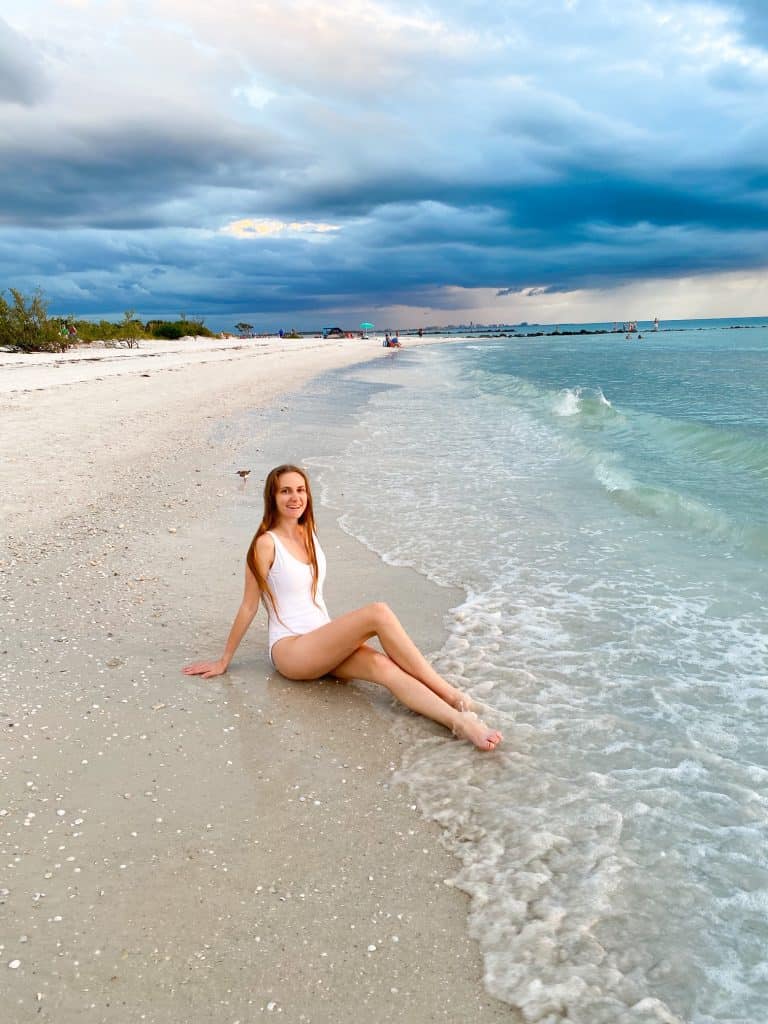 sitting and smiling on North Beach in honeymoon Island