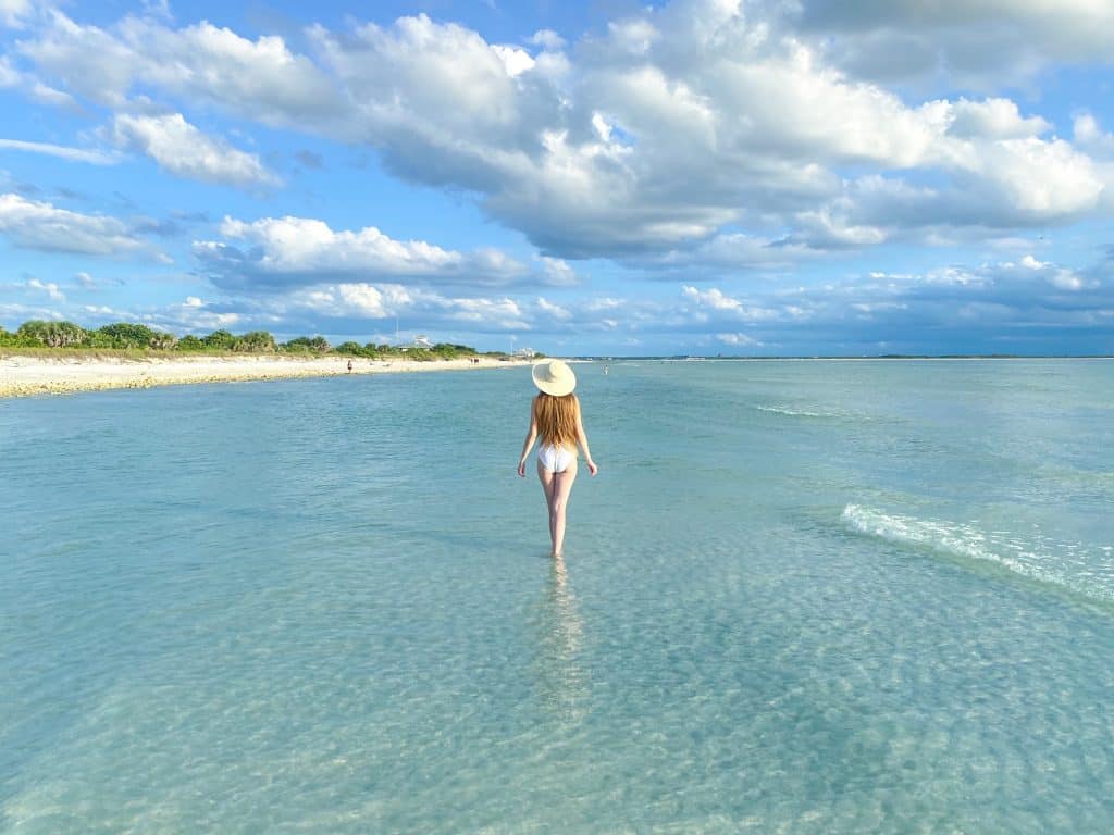 Walking through the shallow waters of Honeymoon Island, perfect for kayaking in Florida.