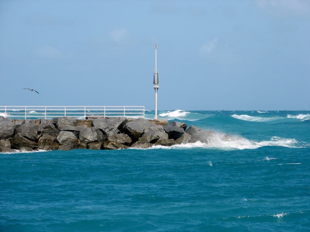 The waves crash into the shoreline, perfect for surfing, one of the best things to do in Jupiter