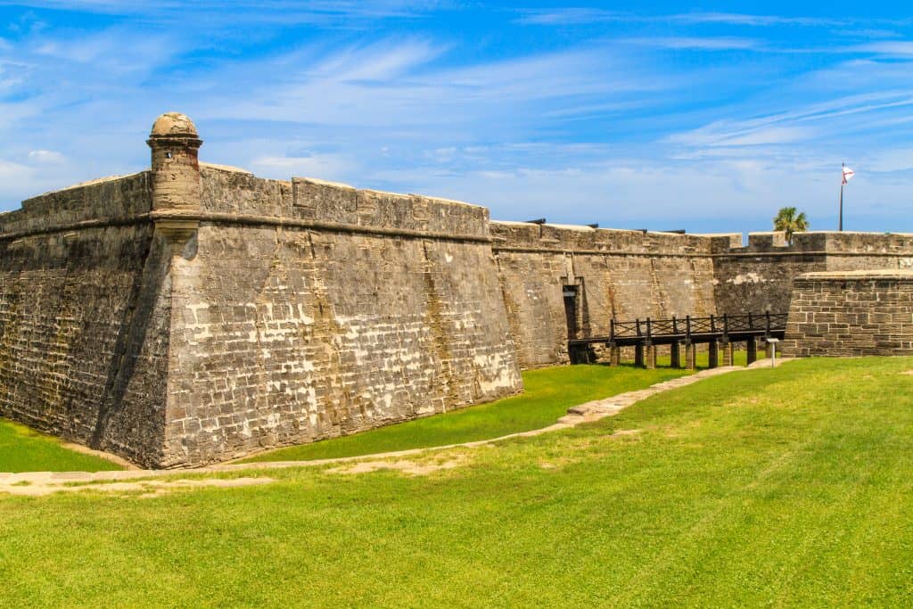 The coquina exterior of the Castillo de San Marcos, a perfect stop on your Florida road trip.