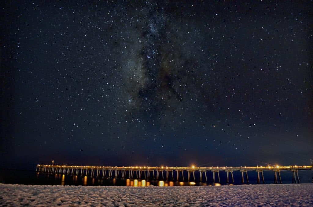 The stars twinkle above Pensacola Beach, one of the best places to go stargazing in Florida.