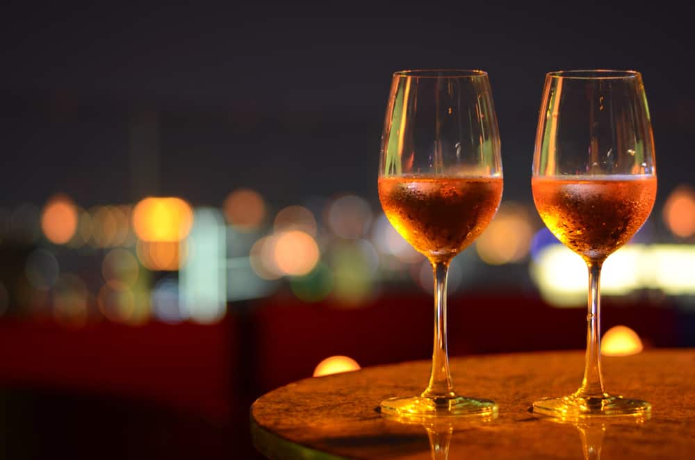 Two glasses of wine against the dark sky
