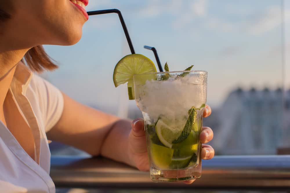 A woman drinking a cocktail