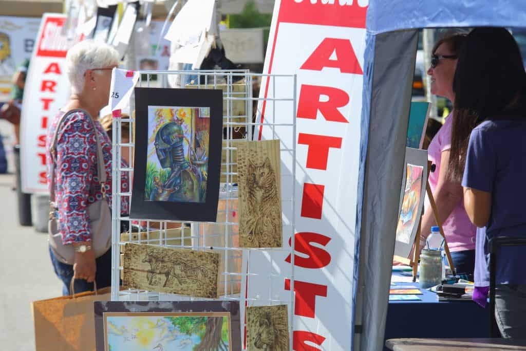 Artists sell wares at a festival in the Eau Gallie Arts District, one of the best things to do in Melbourne, Florida.