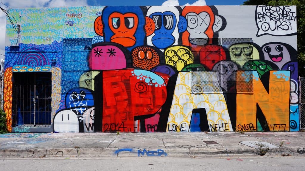 A mural features chunky lettering and crudely drawn monkeys in bright colors.