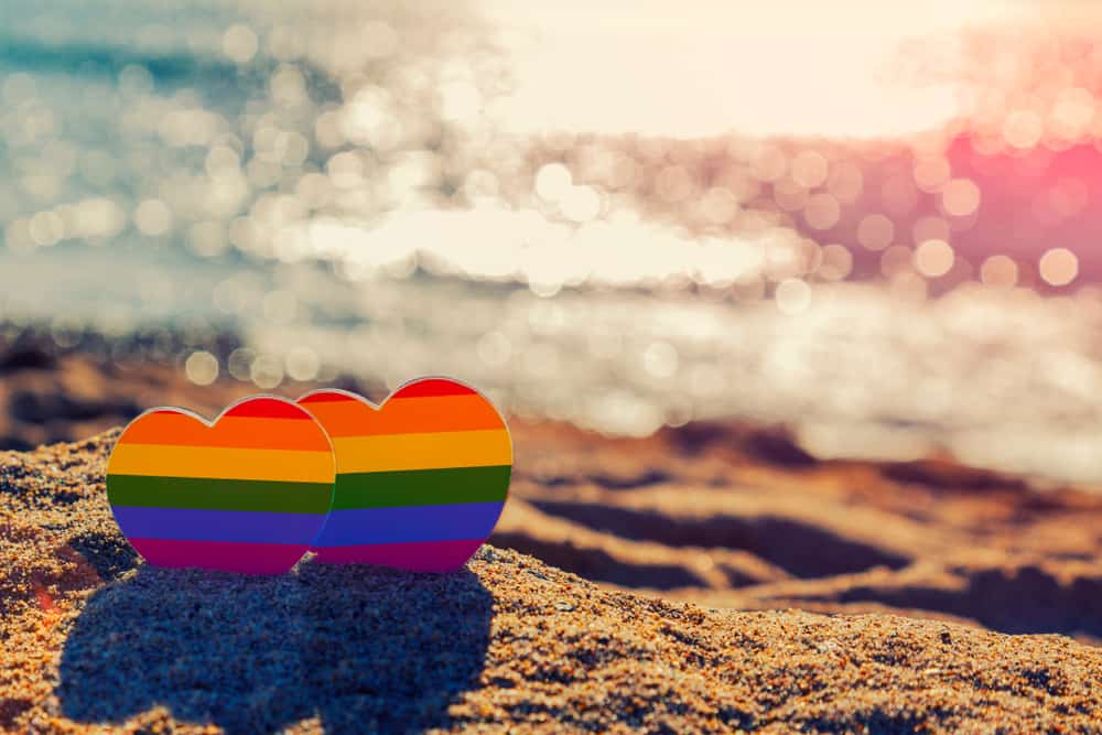 Two love hearts on a beach in an article about gay beaches in Florida