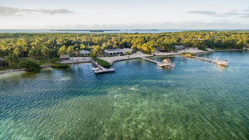 An aerial drone captures the blue-green waters and docks of Islamorada, one of the cutest small towns in the Florida Keys.