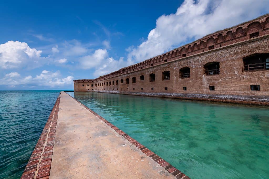 A walkway through the water surrounds Fort Jefferson at Dry Tortugas National Park, one of the best things to do in the Keys.
