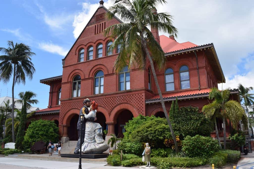 A statue of a couple dancing marks the entrance to the Key West Art & Historical Society.