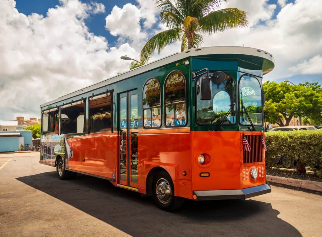 Photo of a bright red-orange Old Town trolley, which is part of one of the best Key West Tours. 