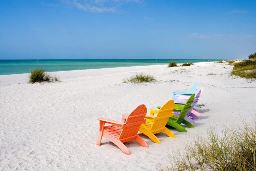 Beach chairs are lined up on the beaches of Captiva Island, one of the best day trips from Naples.