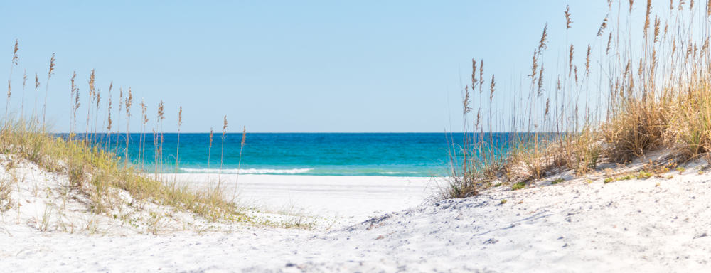 A white, sandy beach on Pensacola, fit for a beach trip on girls getaways in Florida