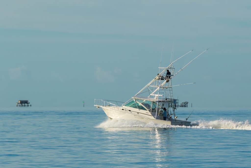 A deep sea fishing vessel ventures out onto the Naples Bay.