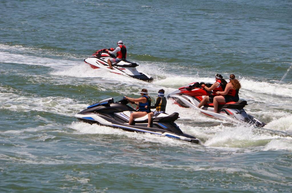 A tour guide shows around guest on jet skis on one of the best Naples boat tours.