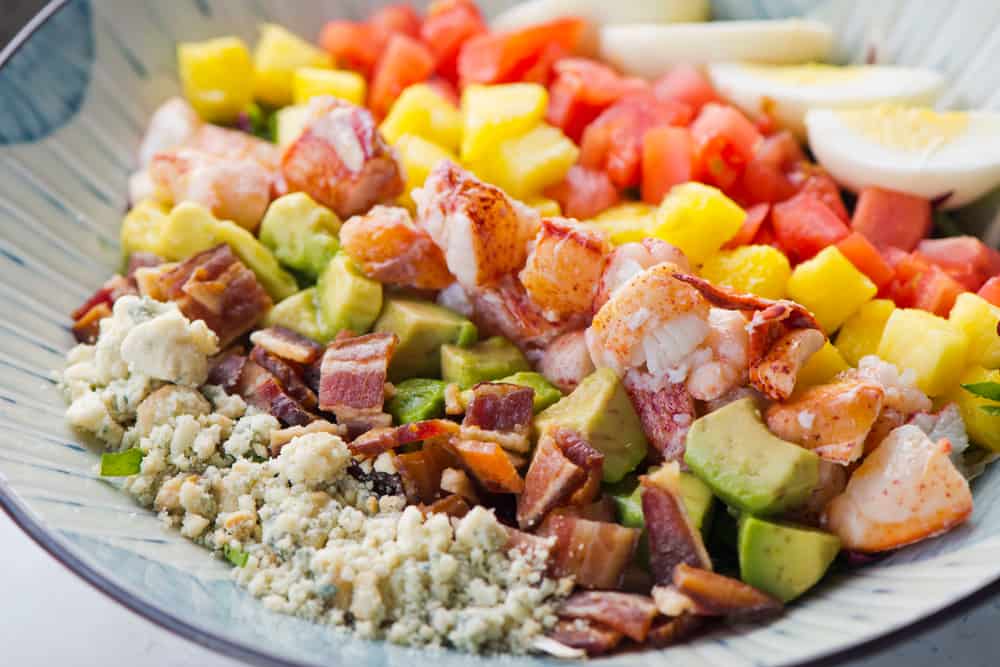 A lobster cobb salad with blue cheese, bacon, avocado, mango, tomatoes and eggs