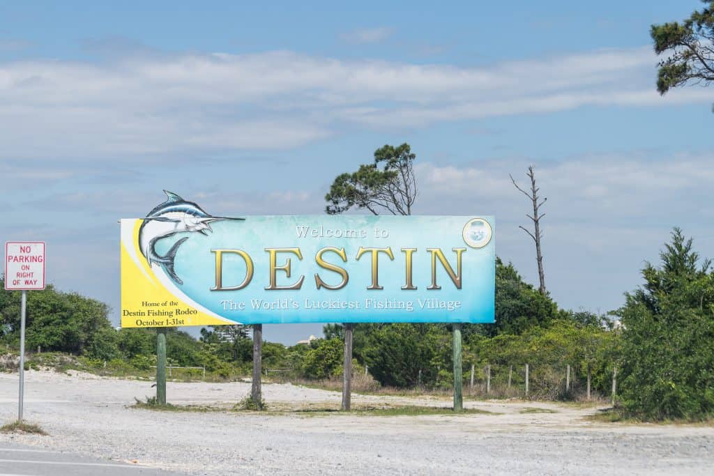 A sign welcomes guests to Destin, where you can find Crab Island