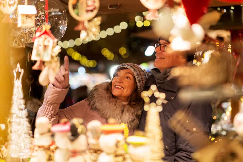 Two people at a Christmas market stall in an article about Christmas in Miami