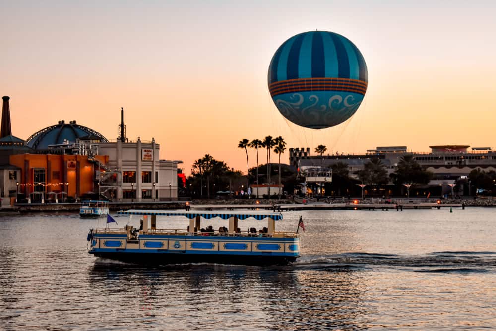 sunset photos looking over the water at Disney springs with a boat and a hot air balloon one of many free things to do in Orlando