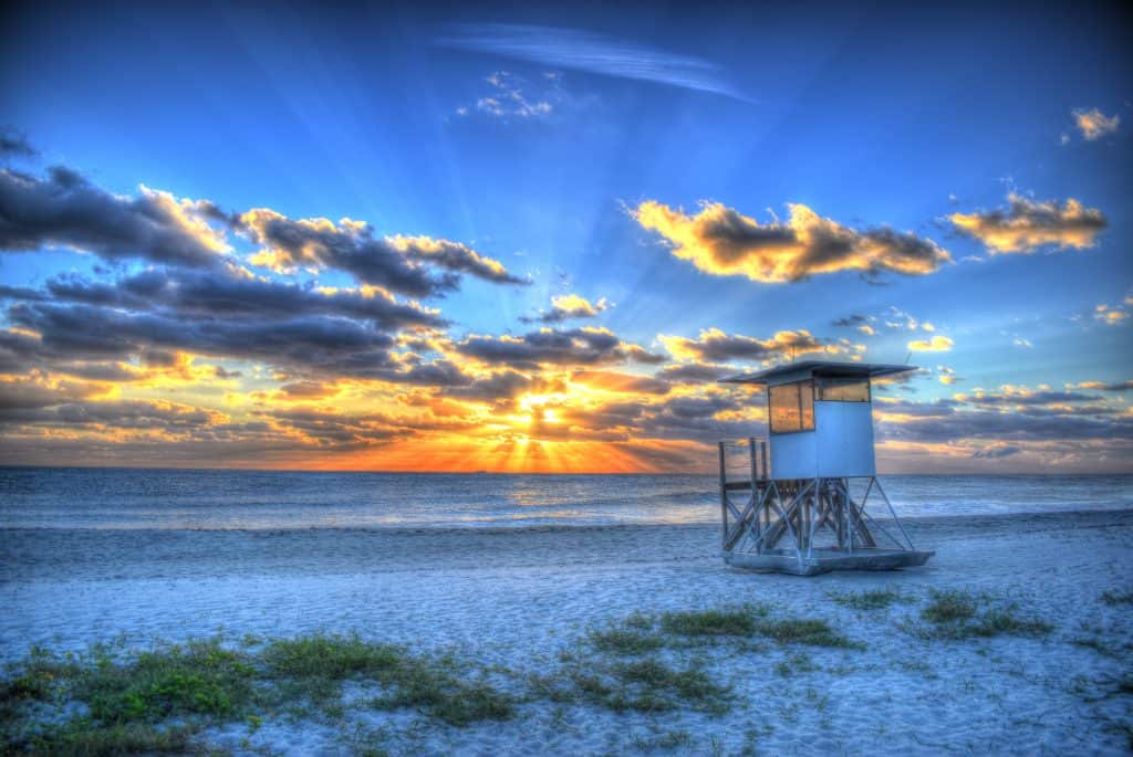 The sun rises over Jupiter Beach and one of its lifeguard stations.