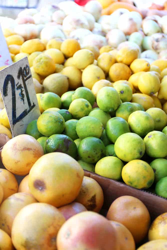 Lemons and limes for sale at an outdoor farmer's market in Florida.