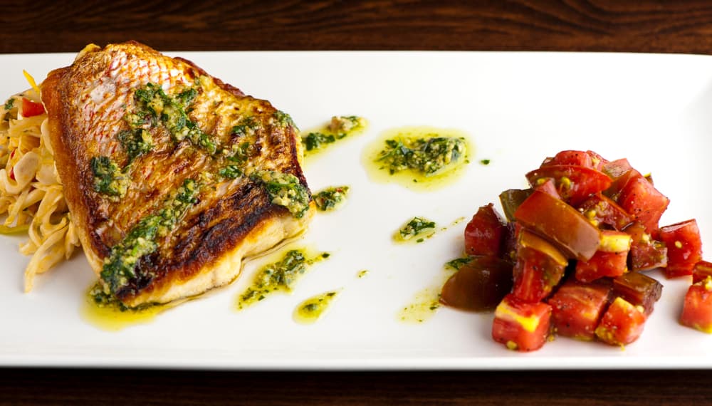 Try one of the global dishes at Little Moir's Food Shack in Jupiter like the pan fried fish in a pesto sauce seared over slaw, and cut up tomatoes