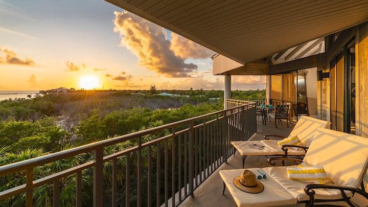 Balcony overlooking ocean at sunset.