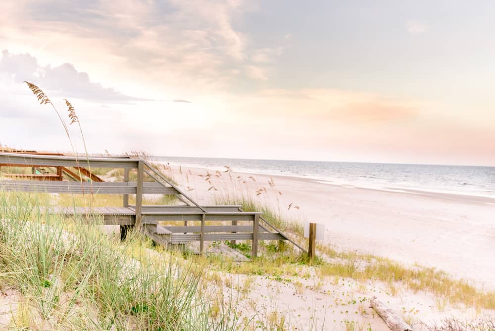 Early sunset over Fernandina Beach on Amelia Island featuring sand dunes and a boardwalk.