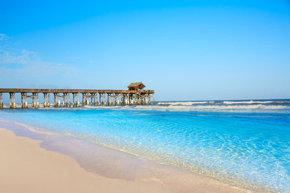 The pier stretching into the clear, blue water of Cocoa Beach.