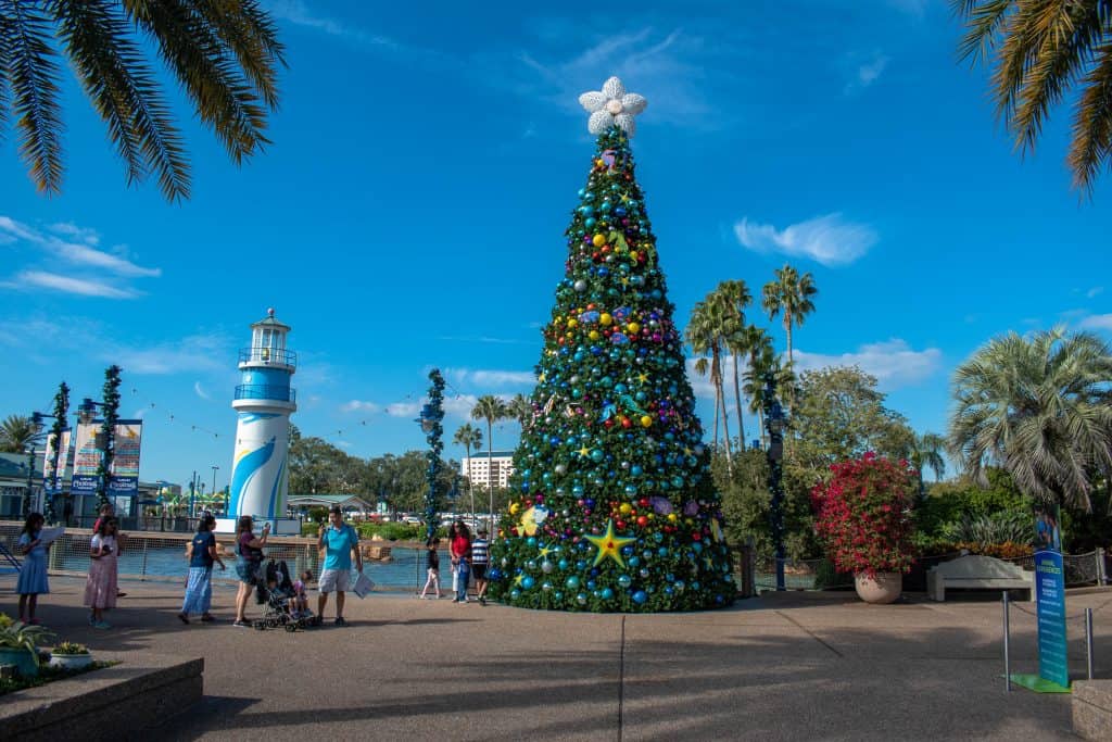 large Christmas tree at SeaWorld's Christmas Celebration in Orlando with blue sky showing off Christmas in Florida