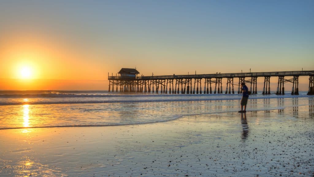 sunrise behind pier at Cocoa Beach day trips from Orlando