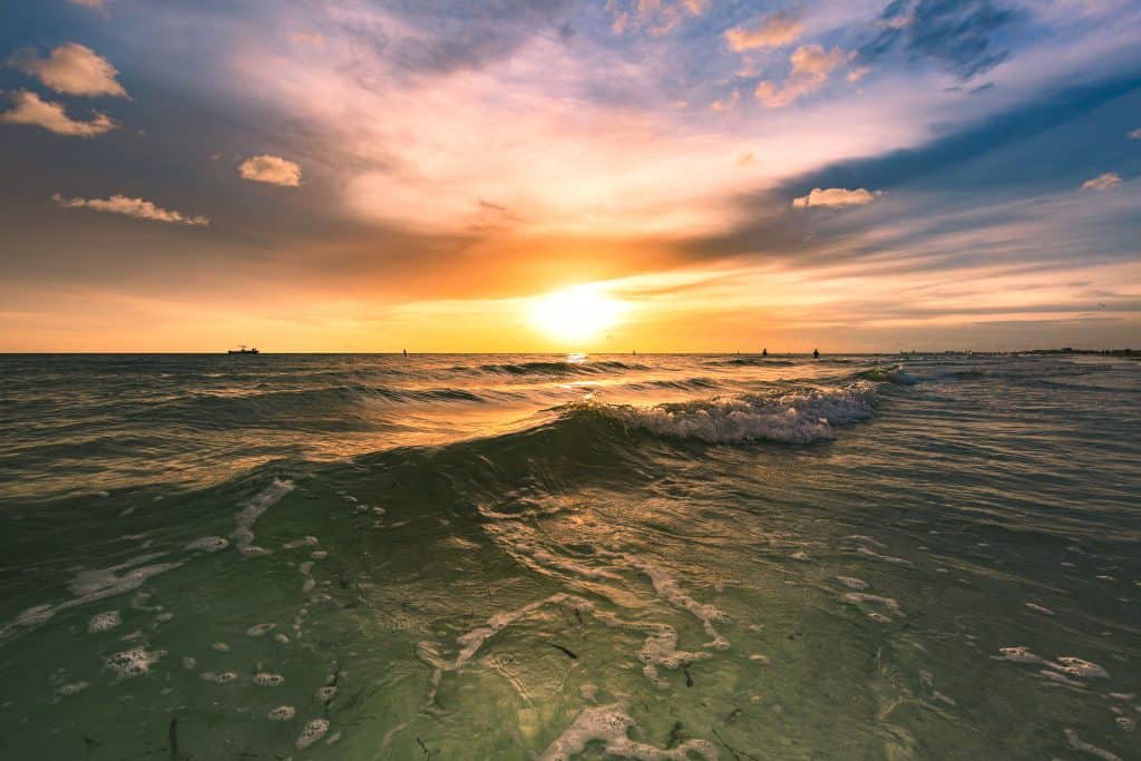 Beautiful sunset over the ocean with waves coming into shore