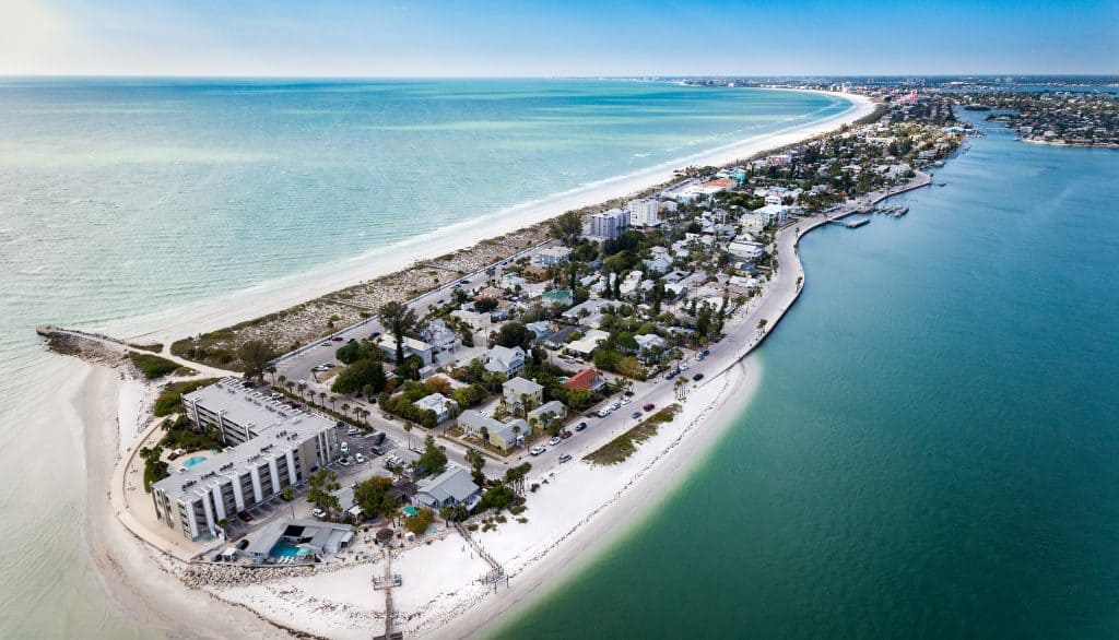 Arial island view of Pass-a-grill at the tip of St. Pete Beach you can see sandy beach areas and the built up areas of the hotels and houses and the bay on the other side of the island