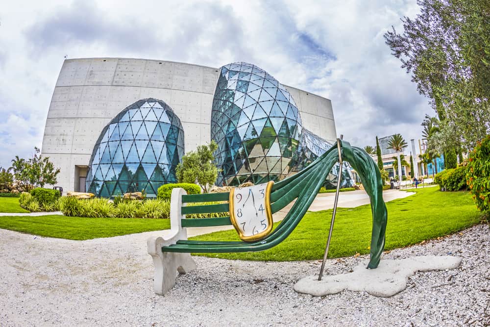 The exterior of the Dali Museum with a surreal bench.