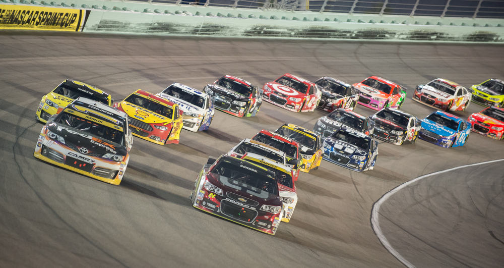 Cars racing around Homestead-Miami Speedway.