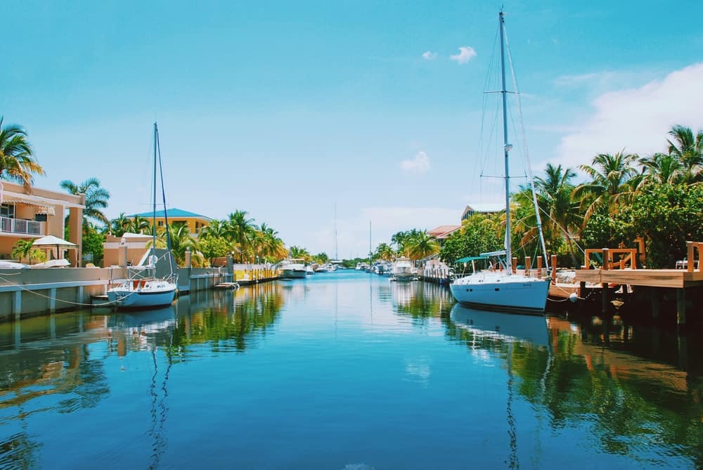 Beautiful boats and houses lining a waterway on the Miami to Key West drive.