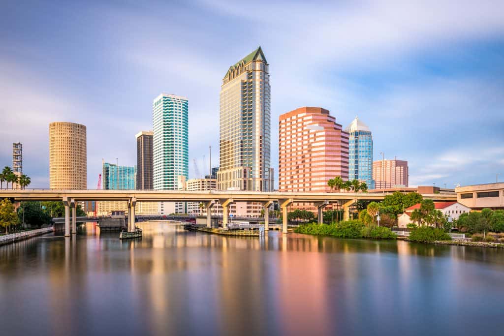 The skyline of Tampa along the Hillsborough River. It is a bright sunny day. 