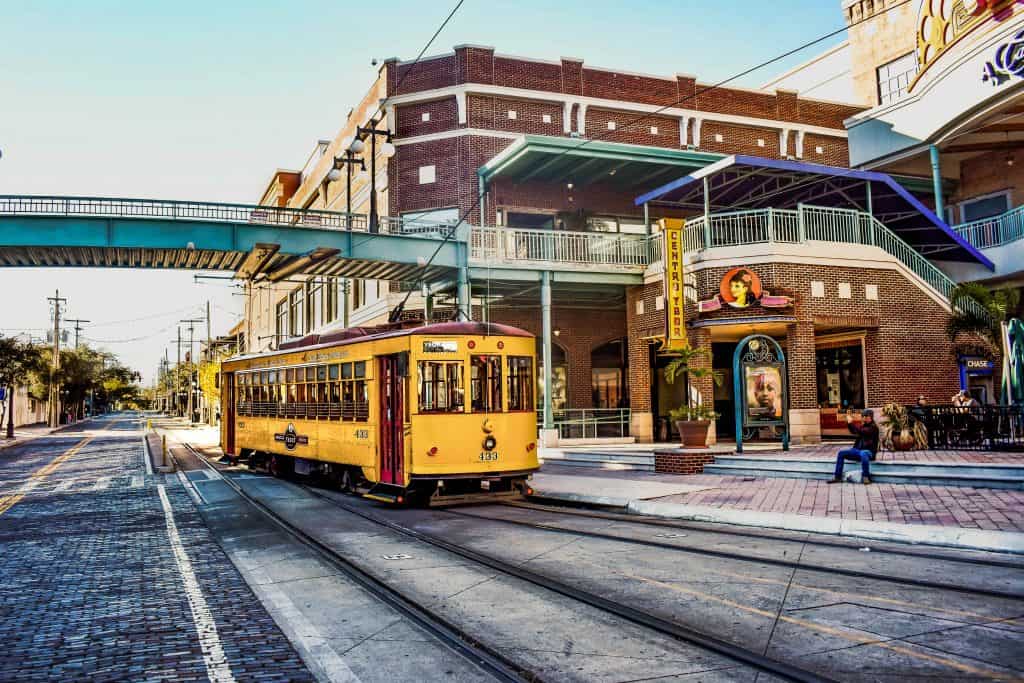 A TECO trolley passes under the pedestrian crosswalk in the Historic Ybor City District.